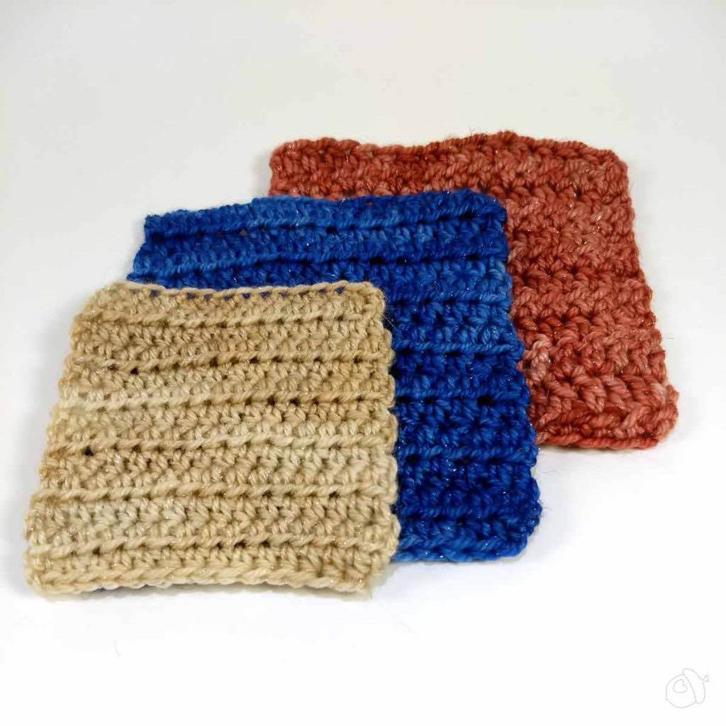 spread of half double crochet swatches in anzula nebula (pale pink), lunaris (deep blue), and lucero (Rusty Red). Three yarns which feature stellina. they are shown on a white background.