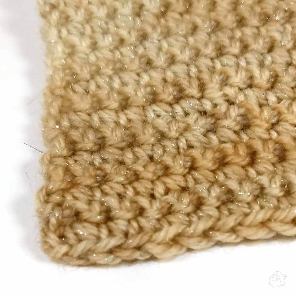 single crochet detail of a swatch in anzula nebula. shown in colorway dusty rose pink on a white background. the stellina is a subtle sparkle