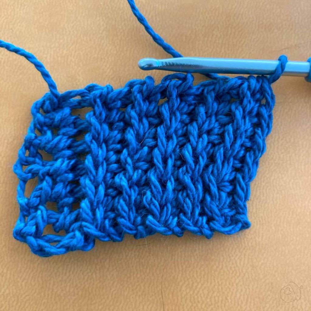 Swatch in progress shown relaxed on hook
