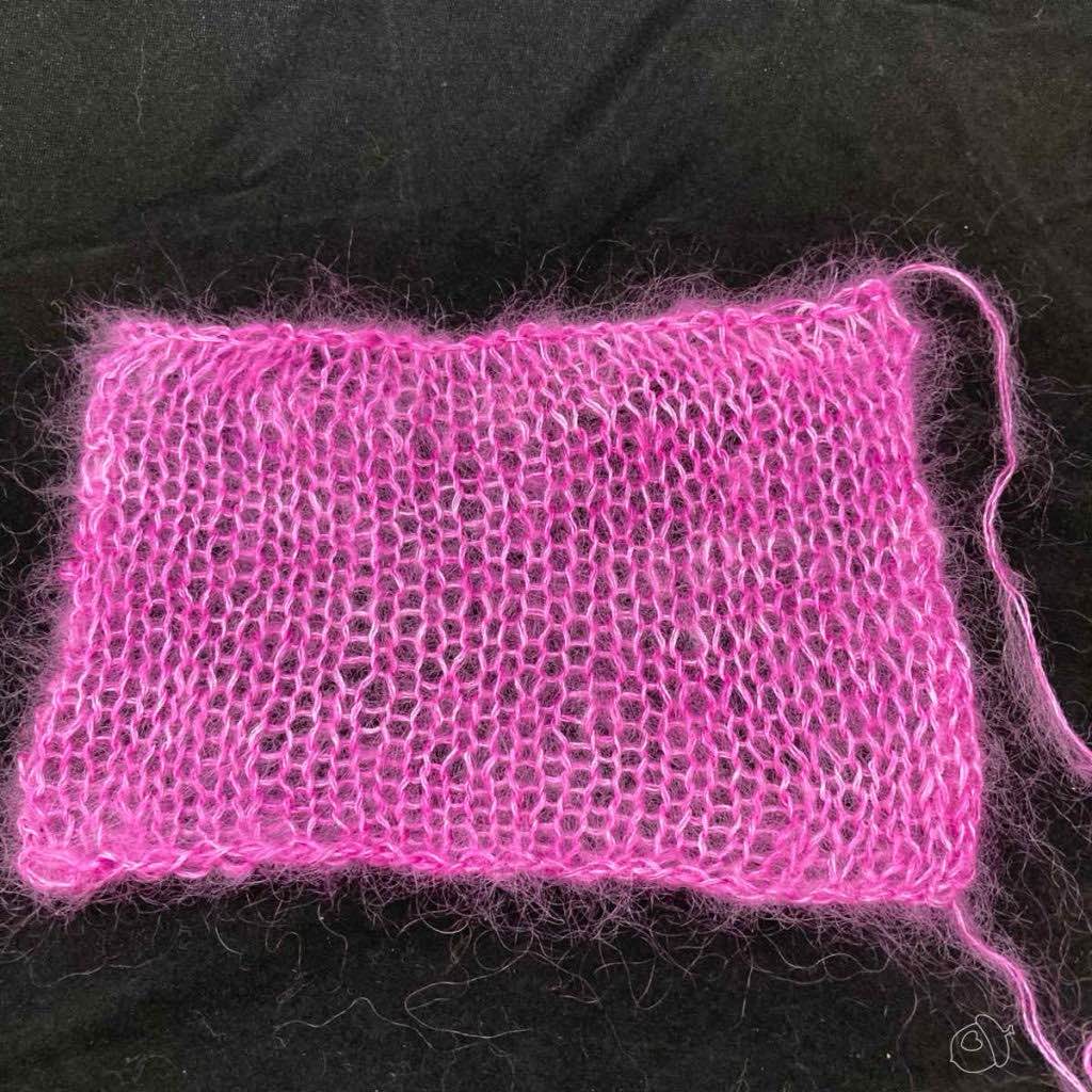pink swatch on black background. The edges are straight-ish.