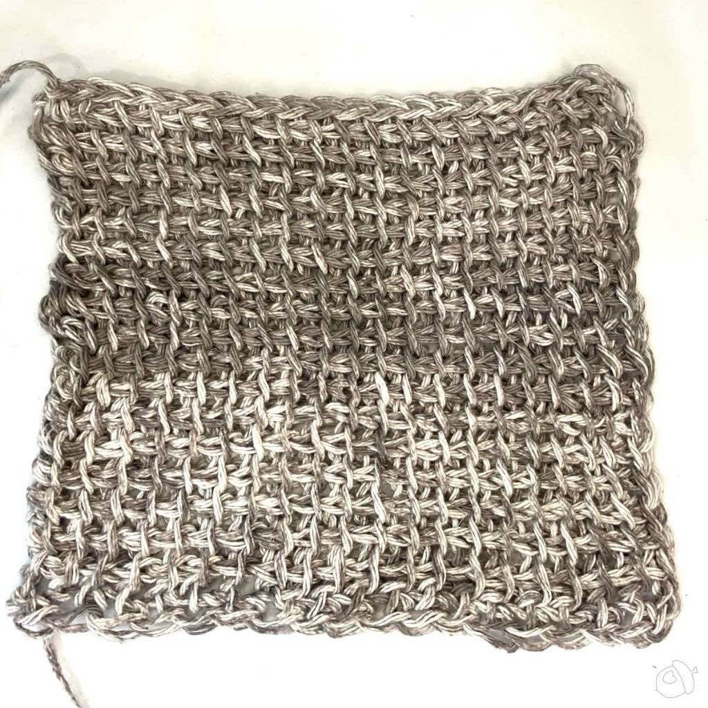 blocked swatch on white surface. TSS in Premier Home, worked on 6.5mm hook