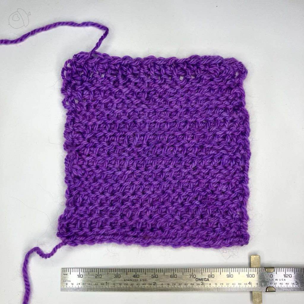 purple Tunisian Purl Stitch swatch in Artyarns Merino Cloud, blocked. it is on a white background next to a ruler showing approximately 4 in / 10 cm width.