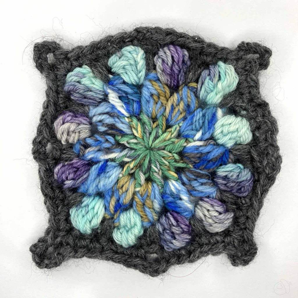 completed crochet motif shown on a white background
